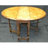 A gateleg table, oval walnut veneered top inlaid with satinwood flora and stringing,