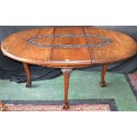 A mahogany extending dining table by Mohamed Amir & Bros,