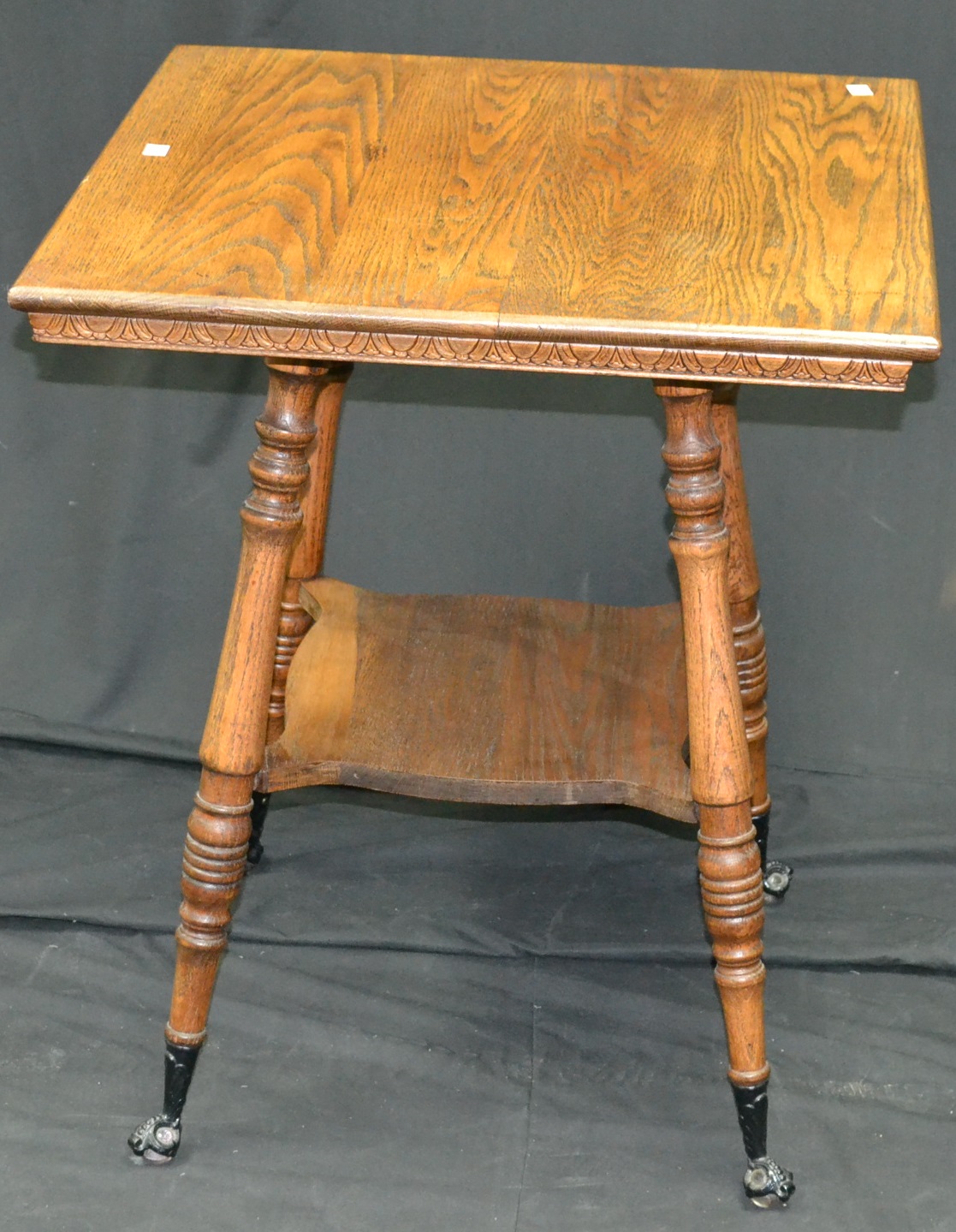 An American oak occasional table, glass and iron ball and claw feet, c.