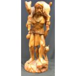 A carved wooden figure group - a hunter, deer across his shoulders and his dog. 100cm high.