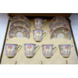 A set of six Royal Worcester coffee cups and saucers, painted in colour with roses and a vase,