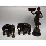 A pair of carved hardwood elephants; a spelter figure,