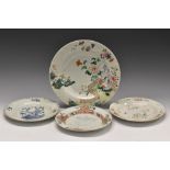 An 18th century Chinese blue and white plate, painted with stylised peony, prunus blossom and fence,