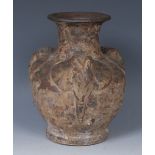 An unusual Indian stoneware vase, in relief with three elephant heads, green mottled glaze, 21.