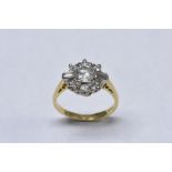 A diamond cluster ring, central round brilliant cut diamond approx 0.