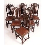 A harlequin set of six Jacobean revival oak dining chairs, pierced and carved with scrolling vine,