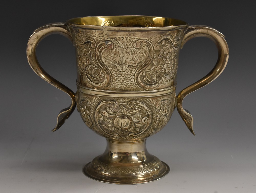 A George III silver bell shaped loving cup, scroll-capped handles, three-quarter girdle,