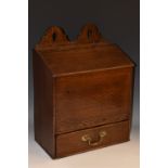 A large George III oak candle box, shaped and pierced cresting, hinged sloping top,