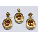 A diamond and Amber Orange sapphire pendant and earrings suite,