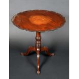 A 19th century mahogany shaped circular tripod supper table, tilting top with pie crust border,