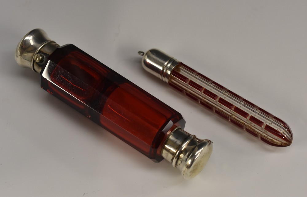 A 19th century silver coloured metal mounted ruby glass double-ended scent bottle,