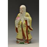 A Chinese Republican Period porcelain figure, of Shou Lao, typically modelled holding a peach,