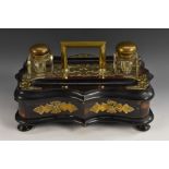 A large Victorian coromandel and ebonised serpentine inkstand,