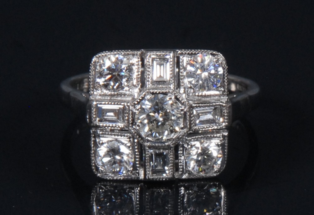 A diamond cross panel ring, central round cut diamond,