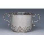 A Charles II silver porringer, chased with a band of acanthus, leafy-S-scroll handles, 19cm wide,