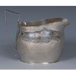 A George III boat shaped cream jug, bright-cut engraved, angular scroll handle, 11cm long, London c.