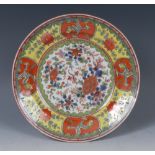 An 18th century Chinese circular plate, decorated with flowers and foliage,