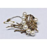 An unusual mid 20th century yellow metal and cultured pearl brooch,