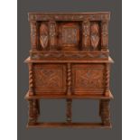 A historicist oak buffet cabinet, rectangular top above a panelled door,