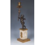 A 19th century dark patinated and parcel-gilt bronze figural mantel light,