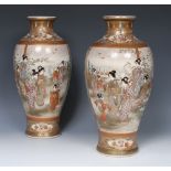 A pair of Japanese Satsuma baluster vases, decorated with Geisha girls in a garden,