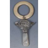 A George VI silver baby's rattle, embossed Baby, teething ring, two bells, mother of pearl haft,