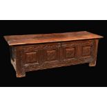 A 17th Century oak blanket chest, hinged planked top, enclosing a till,