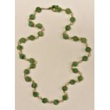 A carved jadite and cultured pearl necklace,