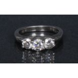 A diamond trilogy ring, linear set with three round brilliant cut diamonds,