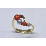 A coral bead and cultured pearl dress ring, shaped linear crest,