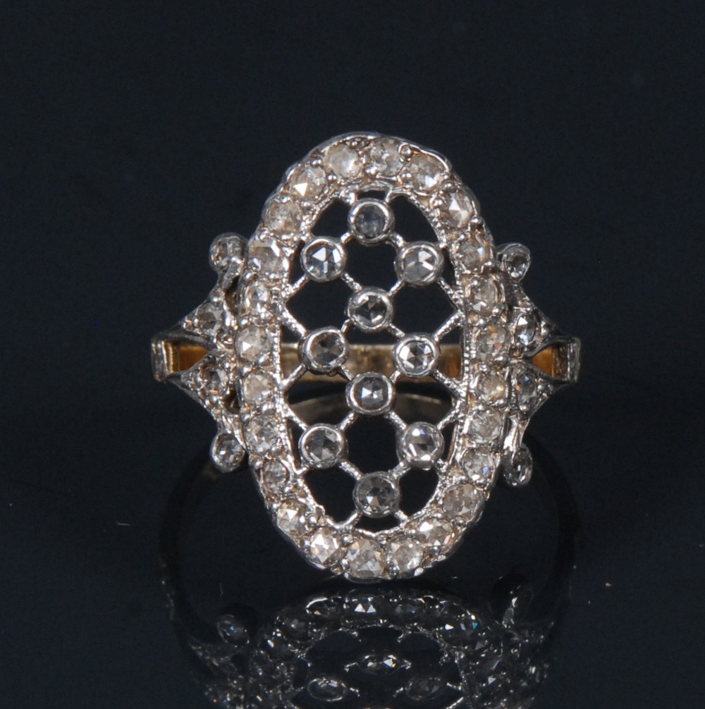 A diamond lattice panel ring, open lattice inset with ten round rose cut diamonds,