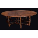 A 17th Century style oak wake table, oval top, bobbin turned legs and stretchers, 77cm high,