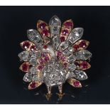 A 19th century diamond, ruby, spinel encrusted peacock brooch, modelled fan tail erect,