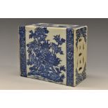 A Chinese opium pillow, each face decorated in underglaze blue with a guardian lion,