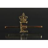 Royal Interest - an Edwardian 9ct gold, diamond and ruby presentation bar brooch,