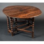 A late 17th/early 18th century oak gate leg dining table, oval top, turned legs,