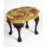 A 19th century Irish mahogany oval stool, stuffed over upholstery,