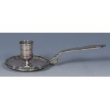 A 19th century French silver pan-handled chamberstick, reel-shaped sconce, piecrust border,