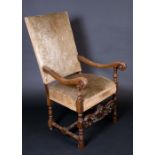 A 17th century style walnut armchair, rectangular back, scroll arms, stuffed over upholstery,