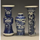 An 18th century Chinese sleeve vase, painted in underglaze blue with with pagodas in a landscape,