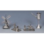 A Dutch silver miniature toy model, of a blacksmith at his anvil, canted rectangular base,