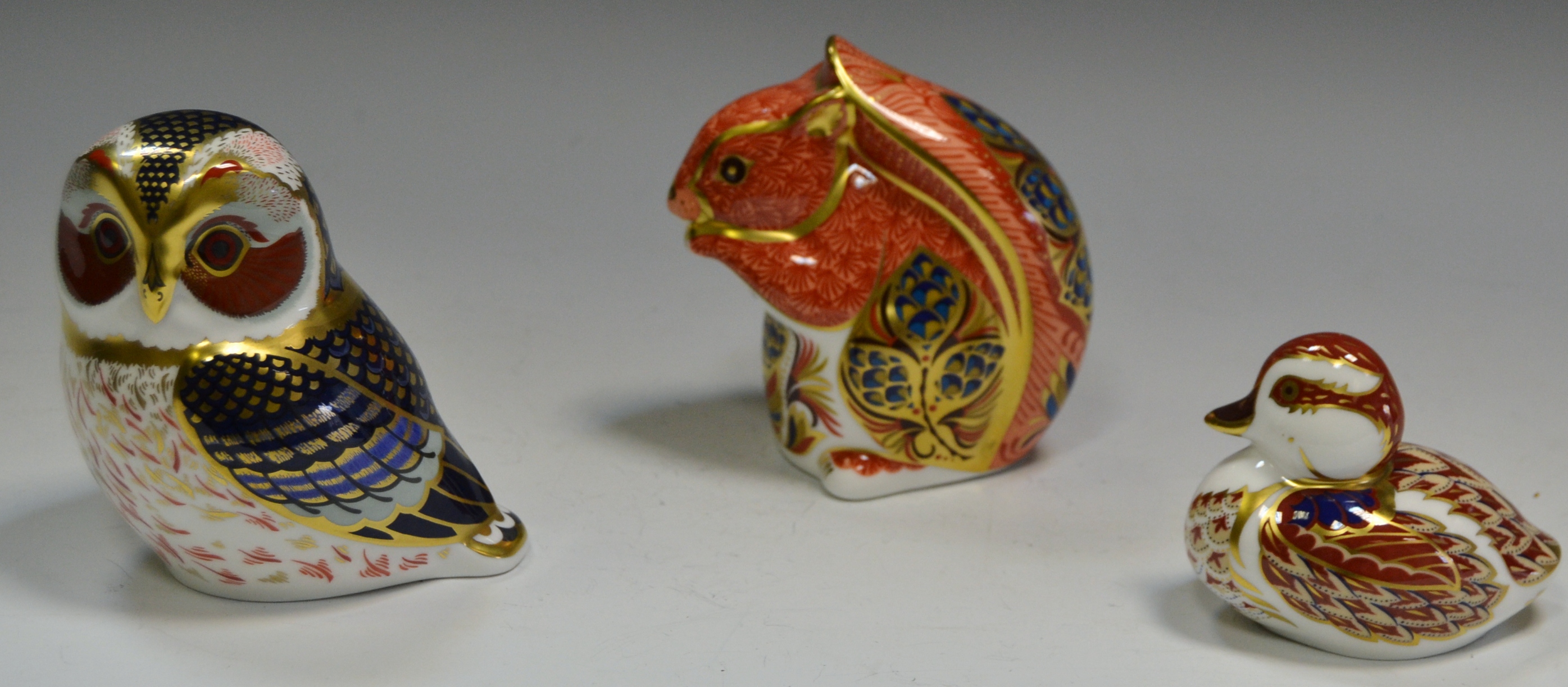 A Royal Crown Derby paperweight, Squirrel, printed mark, gold stopper; others,