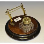A Victorian walnut and ebonised inkstand, glass well with hinged cover, brass pen stand, c.