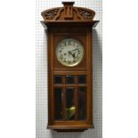 An Art Deco style oak cased wall clock, silvered dial, Arabic numerals, eight day manual movement,