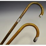 A George V silver mounted palmwood walking cane, Birmingham 1910; another,
