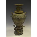 A French bronzed urn decorated in relief with foliage and two panels depicting a boat in high seas,