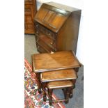 A Priory oak nest of tables; a Priory oak bureau,