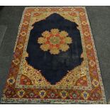 A large woollen English rug. 275cm x 275cm.