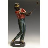 An 20th century cold painted bronzed model of a golfer in mid swing