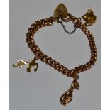A 9ct gold graduated Albert bracelet with charms and heart locket, hallmarked 27.